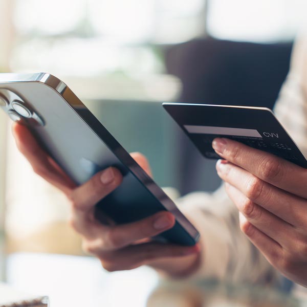 hands holding card and phone